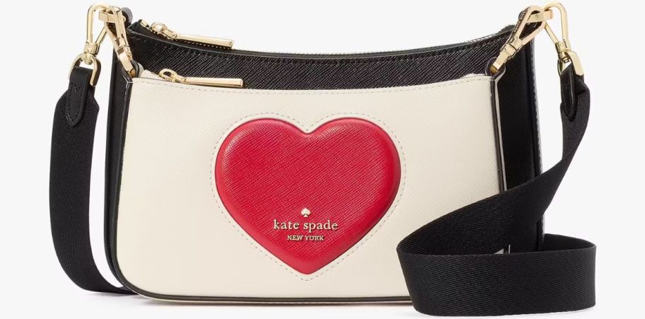 a small crossbody bag with a red puffy heart design on the front