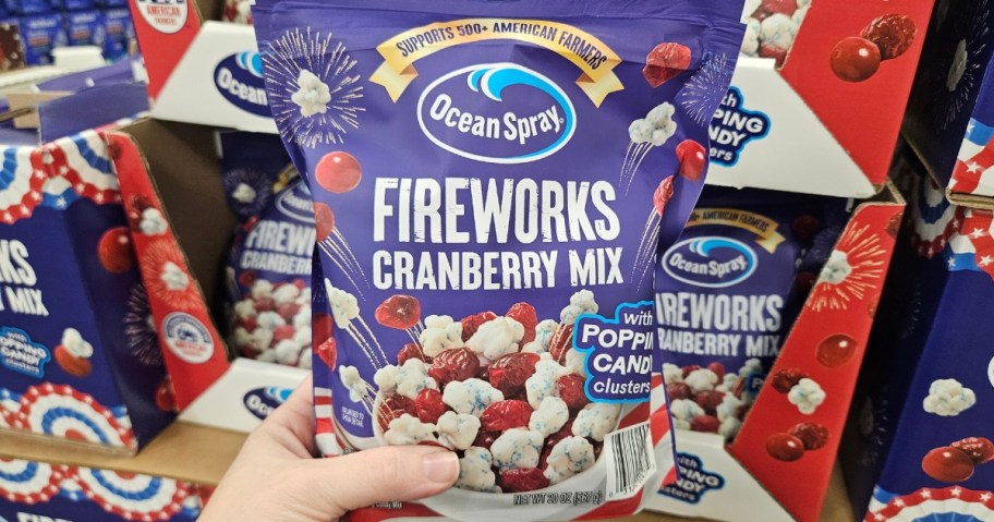 hand holding a bag of Ocean Spray Fireworks Craisins