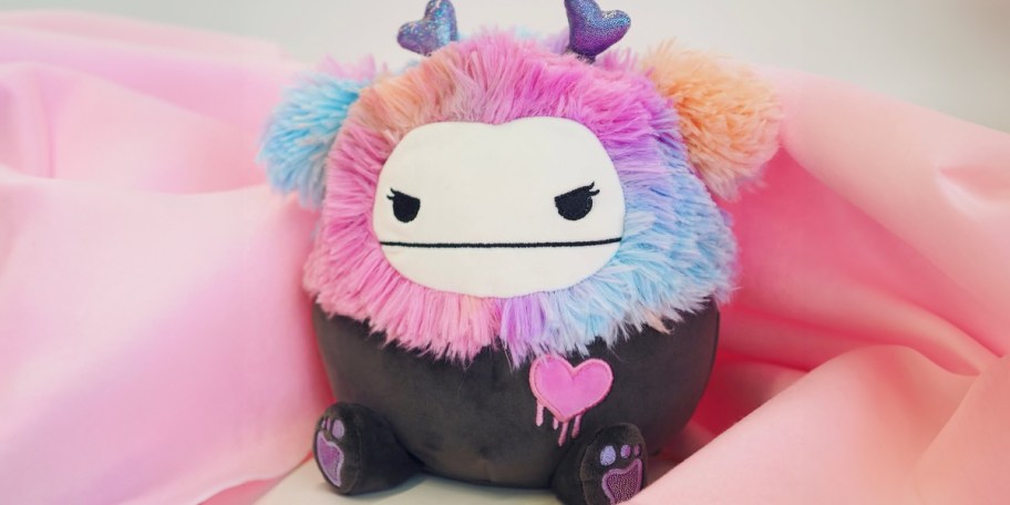 squishmallows goth bigfoot plush on pink blanket