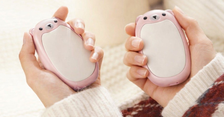 person holding pink bear hand warmers
