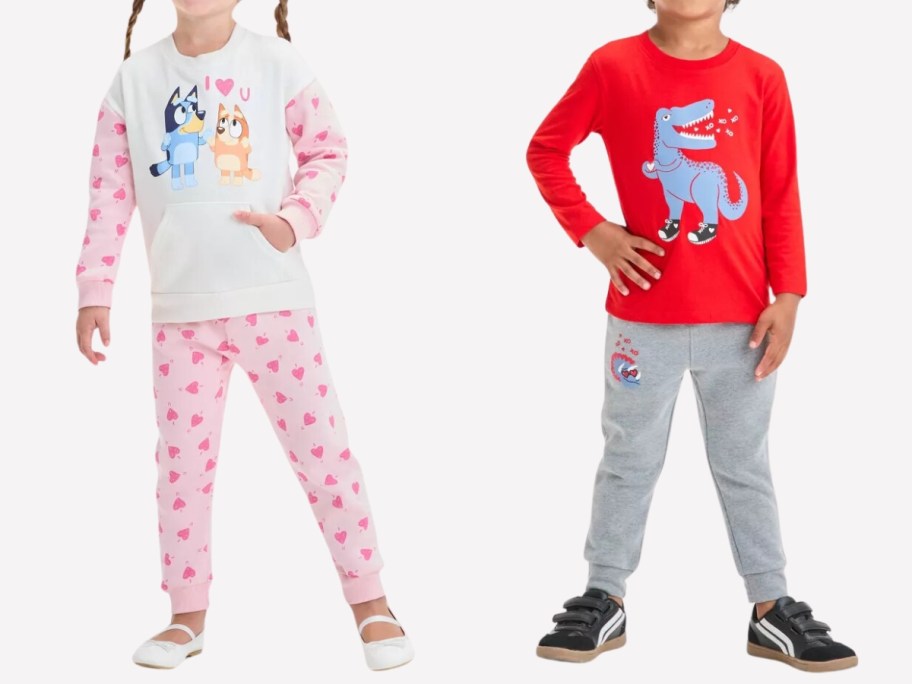 little girl wearing a pink and white Bluey and Bingo long sleeve top and pants and a little boy wearing a red red shirt with a Dinosaur on it and grey pants