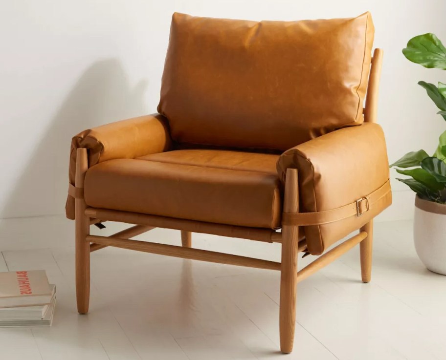 faux leather camel colored chair on gray concrete floor