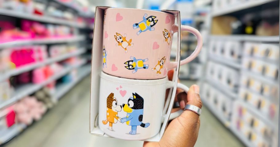 bluey mugs in hand in store