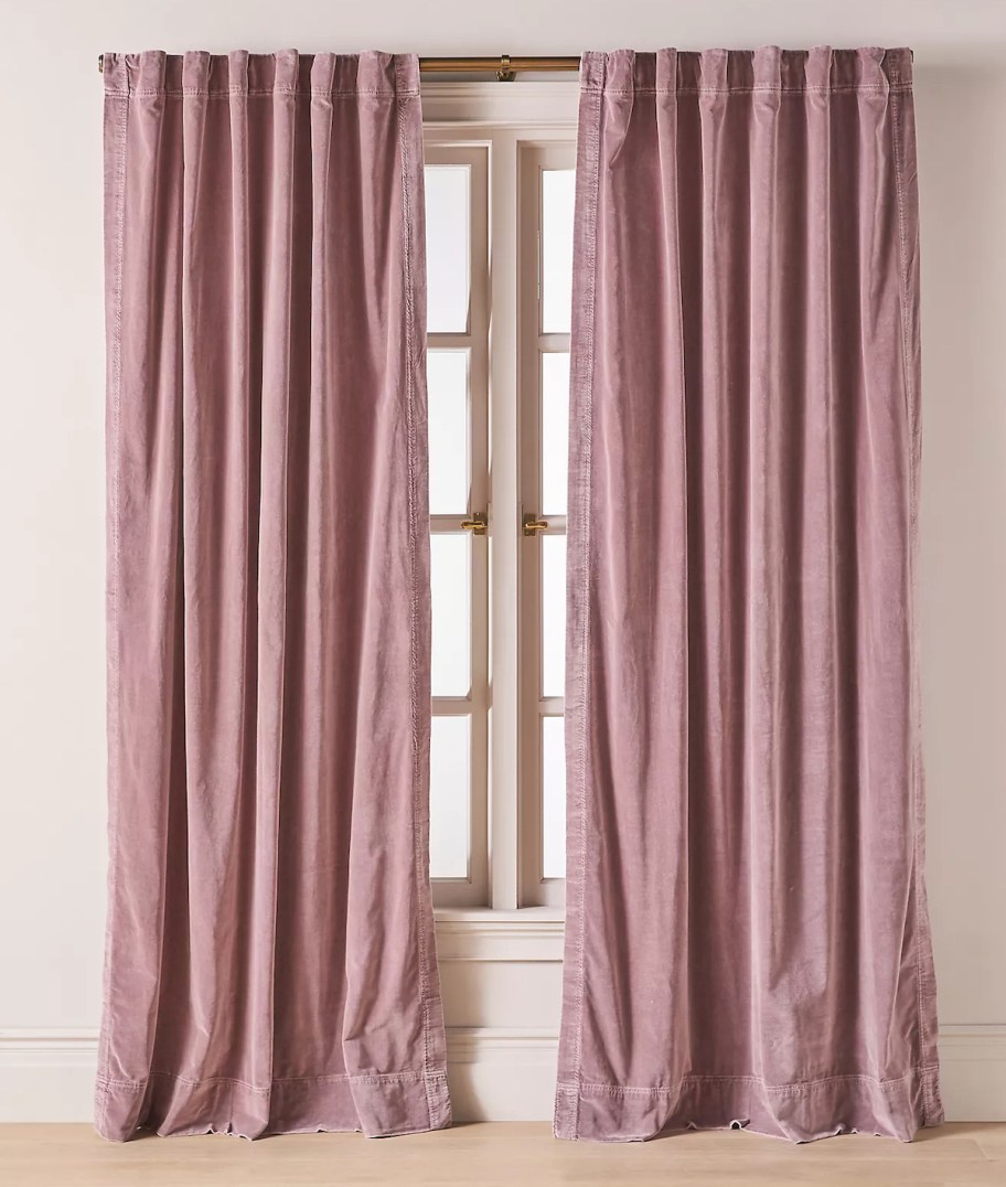 Purple velvet curtains, hanging out the window