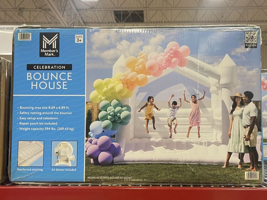 a white inflatable bounce house in a box on a store shelf