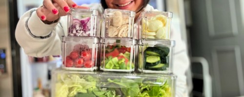 woman holding salad bar fridge prep containers