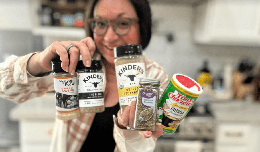 woman holding various seasoning blends