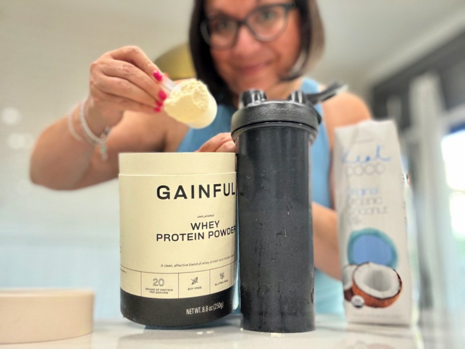 woman scooping protein powder