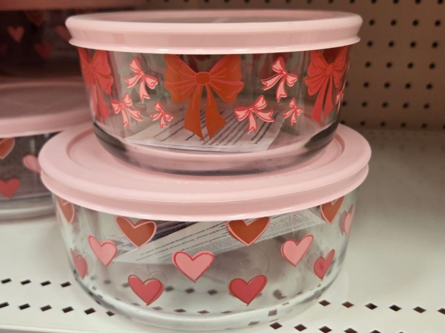Two Anchor Hocking Glass Valentine's Day Food Storage Containers with hearts and bows with pink lids