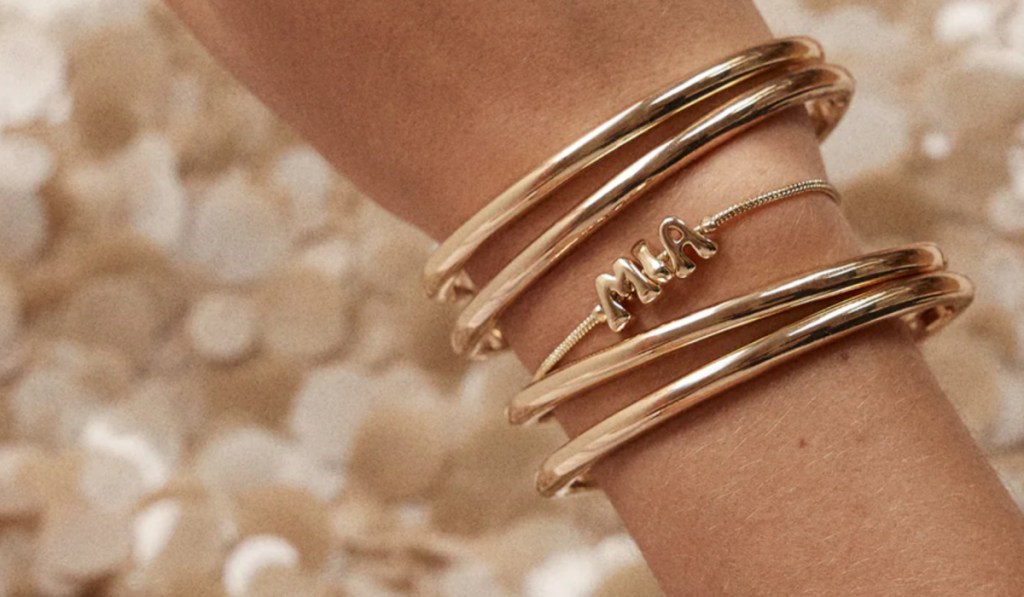 Woman wearing gold bangle bracelets