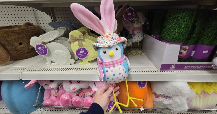 Hand holding a bird with bunny ears tabletop easter decoration at Dollar Tree
