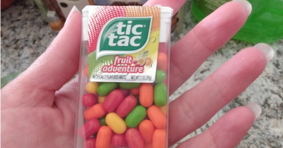 hand holding a pack of Tic Tac fruit adventure candies