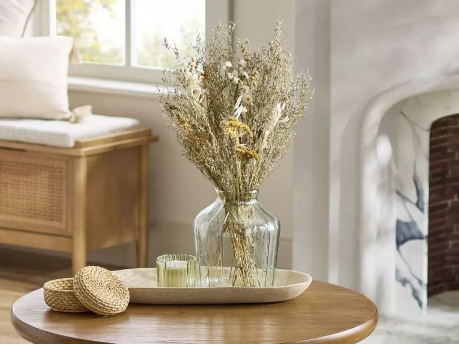 Hearth & Hand w/ Magnolia 25" Preserved Spring Grass & Flower Stems Bundle in vase on table in living room