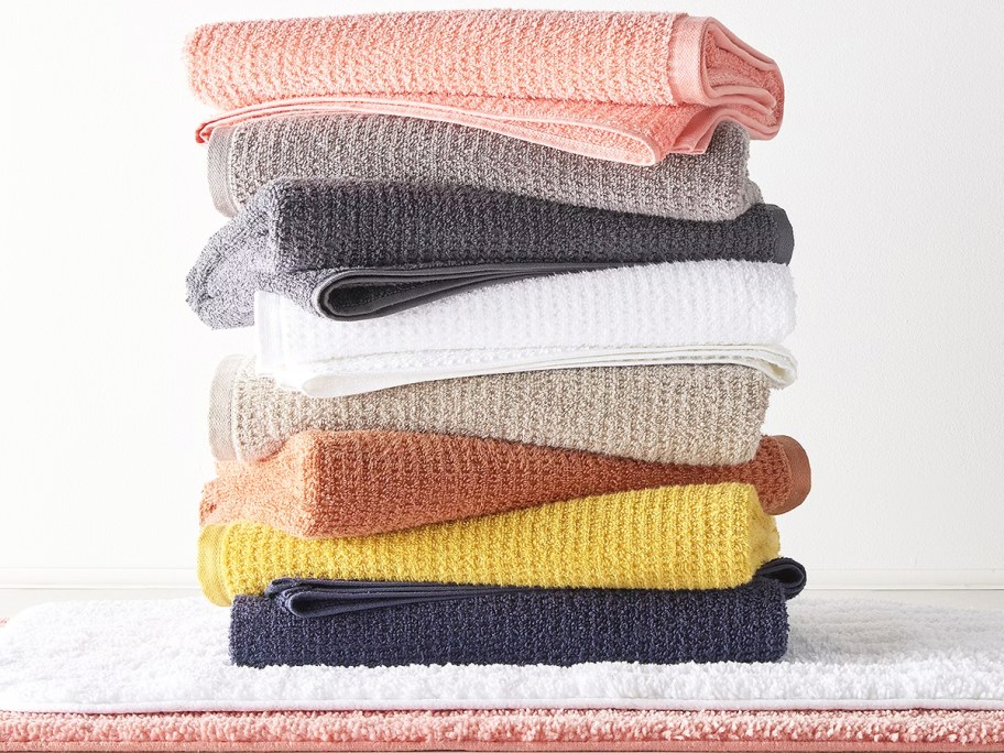 stack of folded bath towels on top of bath mats