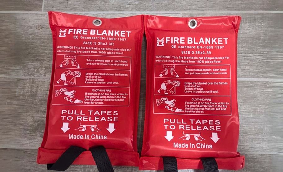 two fire blankets in red emergency packaging with pull tabs