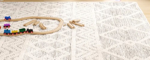 wool rug on floor with wooden toy train
