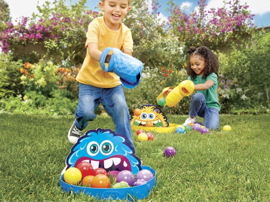 kids playing with the Little Tikes Feeding Frenzy game in a backyard