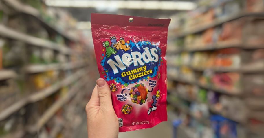 hand holding a bag of Nerds Gummy Clusters in a store aisle