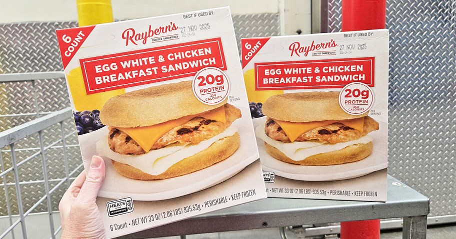 hand holding box of Raybern's Breakfast Sandwiches with another box in background