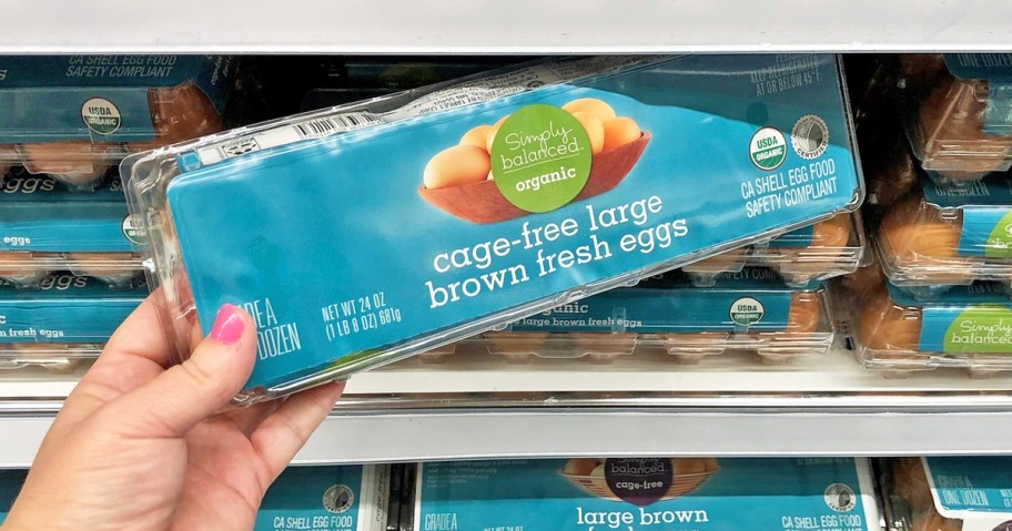 hand grabbing a dozen eggs from store shelf