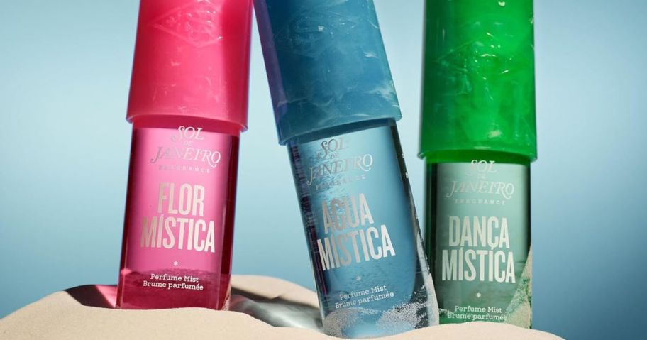 3 Sol de Janeiro fragrance bottles in the sand
