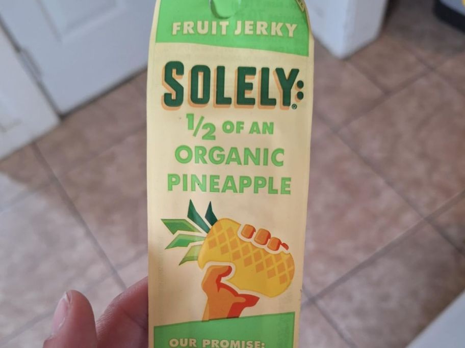 A person holding a Solely Organic Pineapple Fruit Jerky