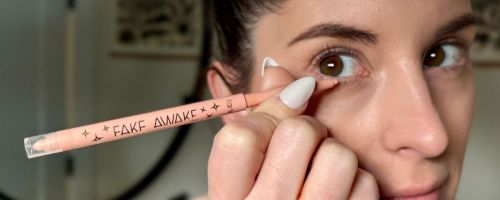 woman applying tarte fake awake to her waterline