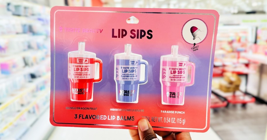 holding up a 3-pack set of mini tumbler lip balms