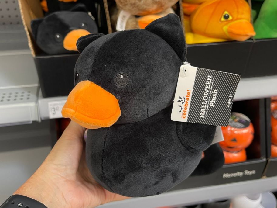 A person holding a green duck 