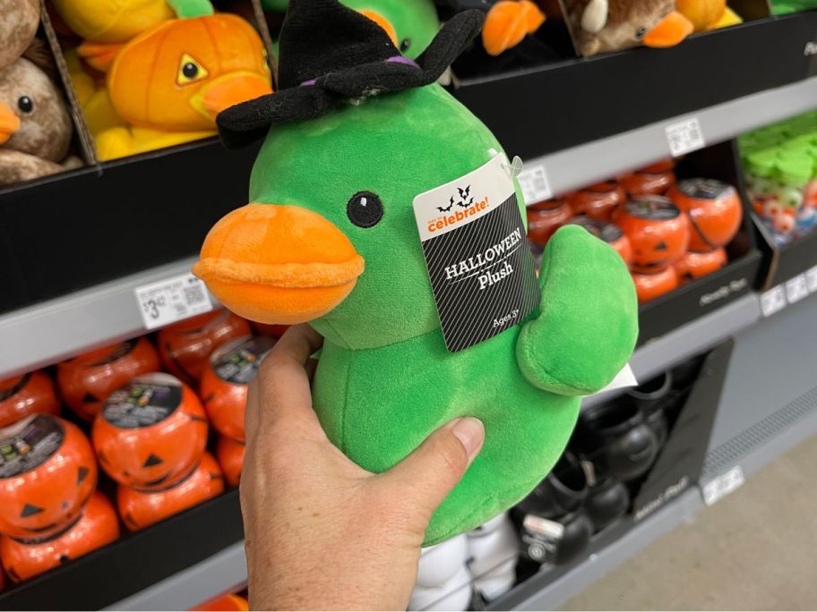 A person holding a green duck 