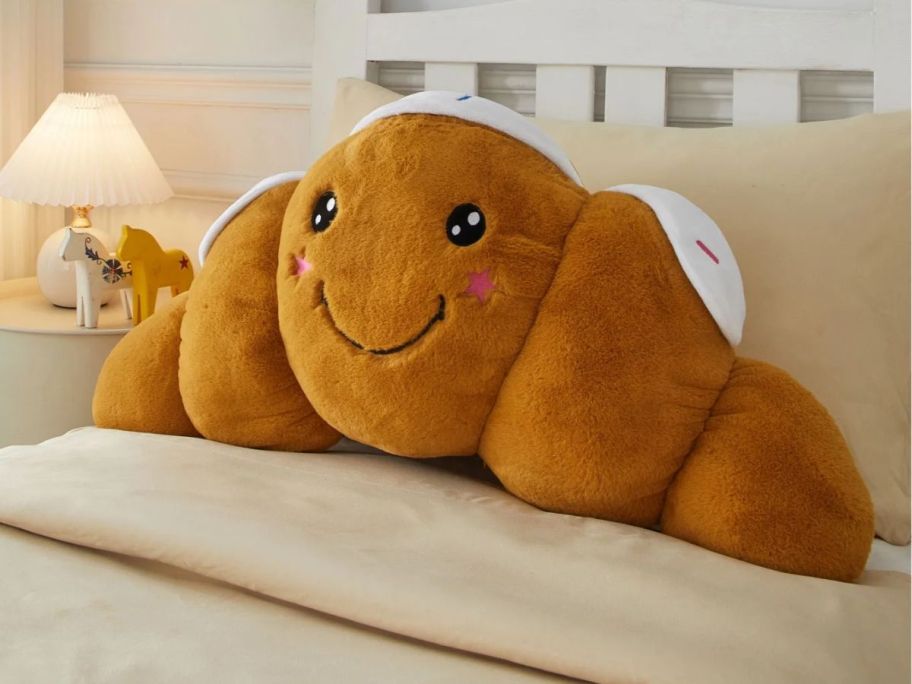 Your Zone Croissant Shaped Plush Body Pillow on bed