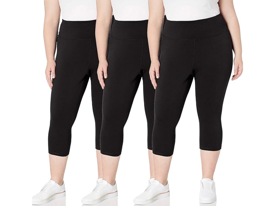 three women wearing black leggings and white tees 