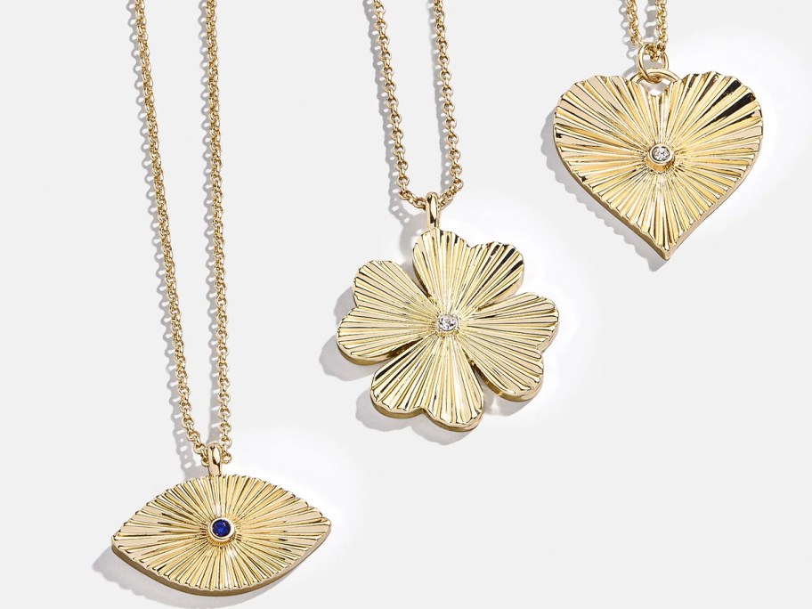 eye, clover, and heart gold necklaces