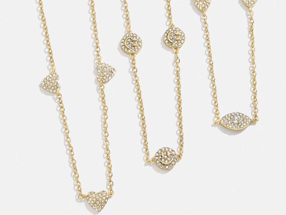 three gold necklaces