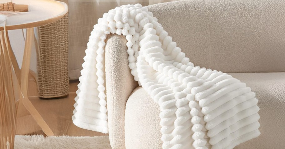 white fluffy blanket placed on a couch