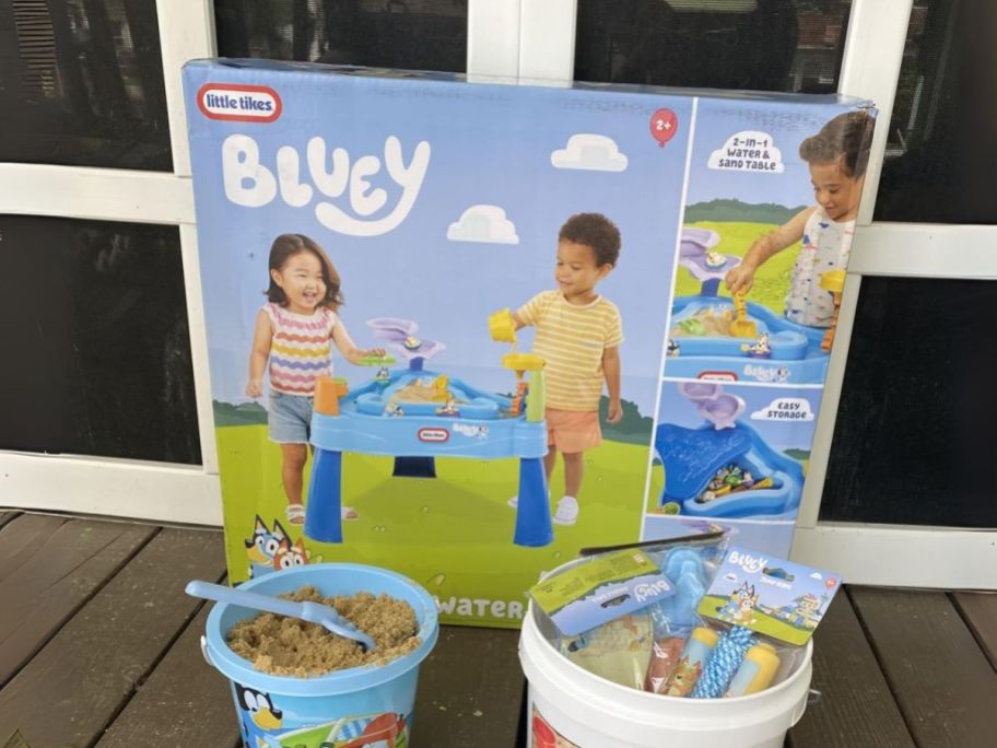 Little Tikes Bluey Water Table box on deck with buckets of sand and supplies in front of it