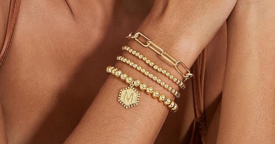 woman's wrist with a stack of bracelets