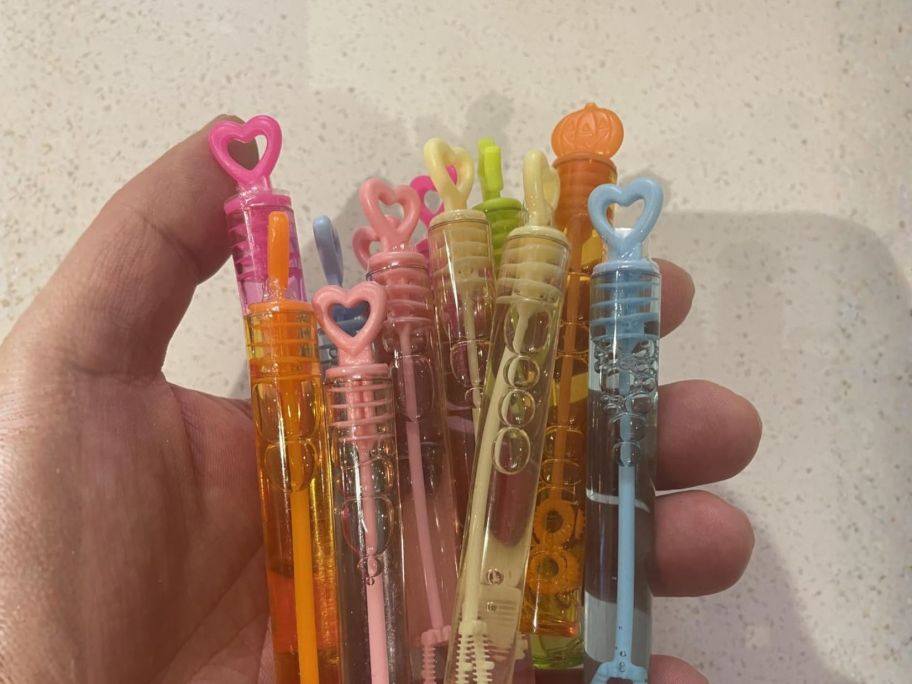 hand holding valentine's day bubble wands