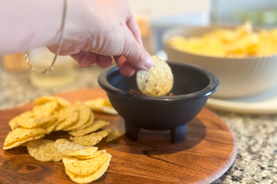 dipping chip in salsa bowl