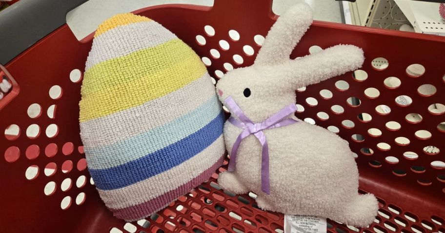 egg and bunny throw pillows inside of shoppimg cart