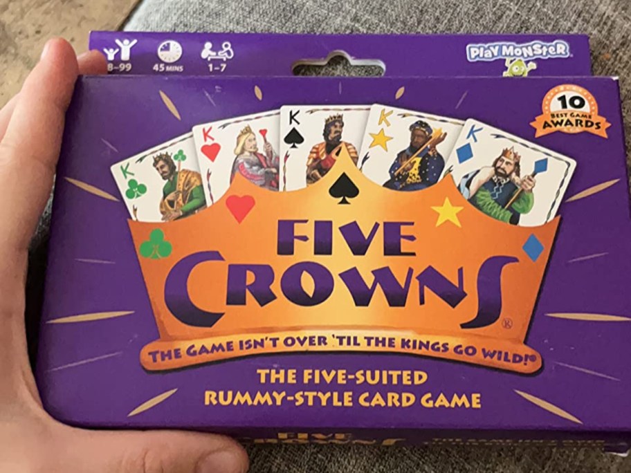 holding a Five Crowns card game in the box
