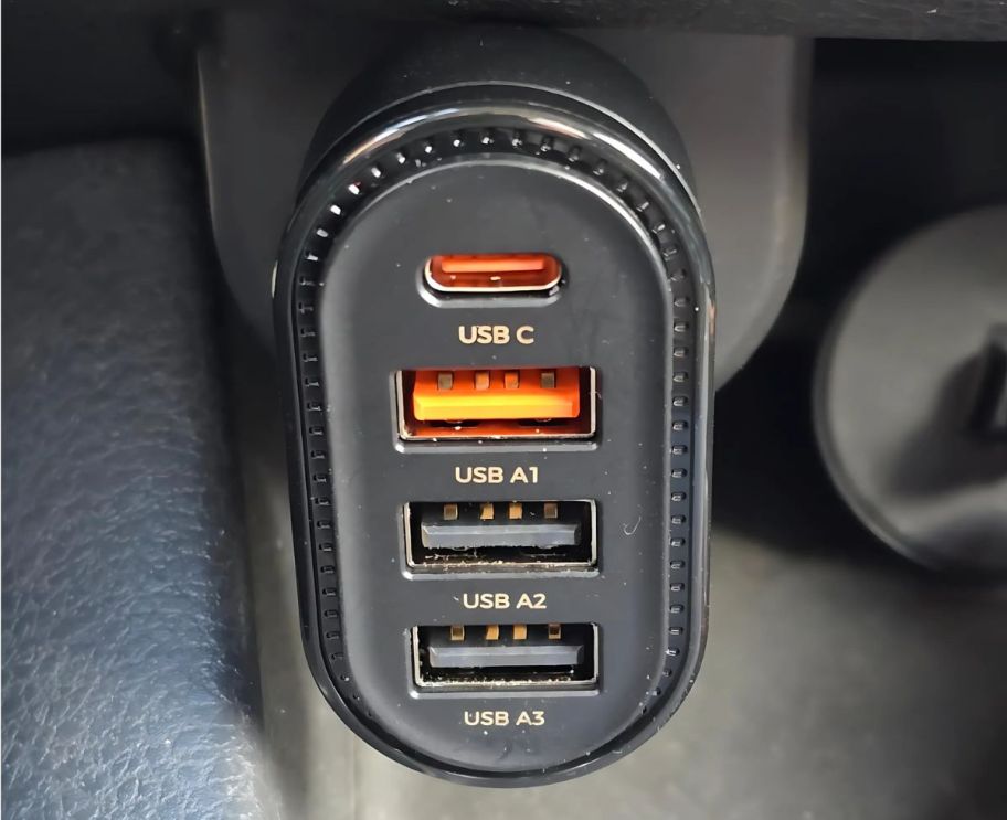 a close up of a USB car charger plugged into an outlet in a vehicle