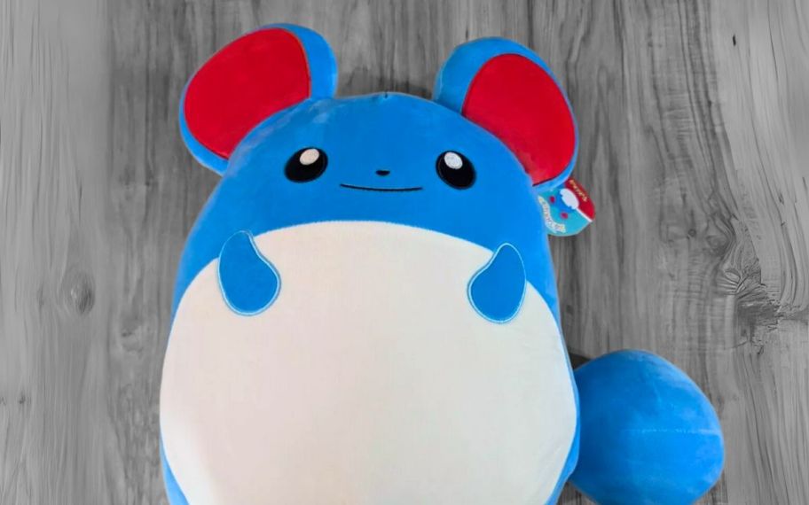 marill mouse pokemon squishmallow on a gray wood plank floor