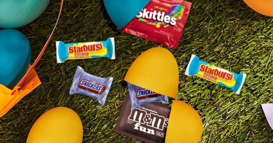 various mini Mars brand candies inside and around plastic Easter eggs