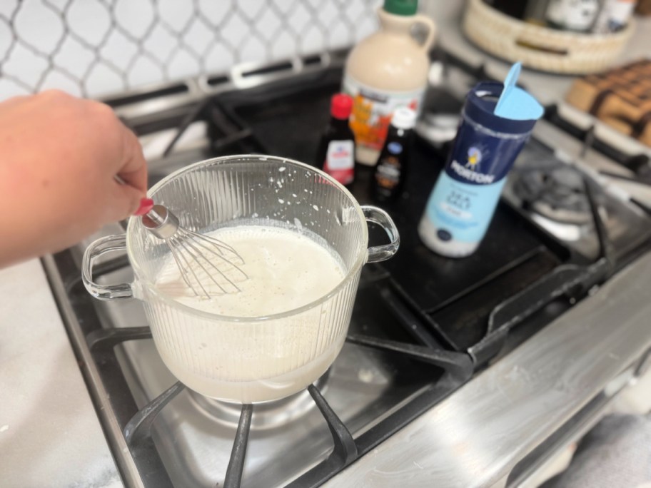 mixing cream and maple syrup to make diy coffee creamer