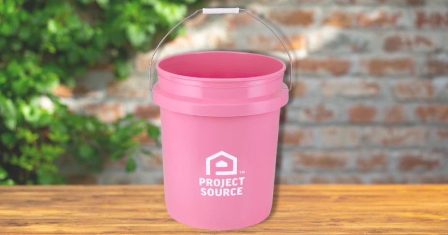 a pink 5 gallon bucket on a table