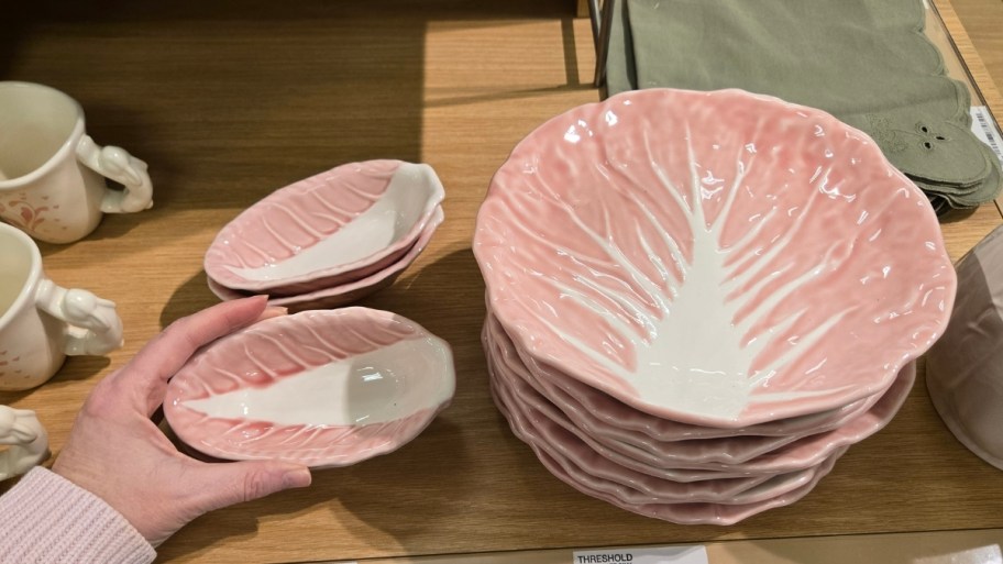 womans hand holding a hand painted bowls