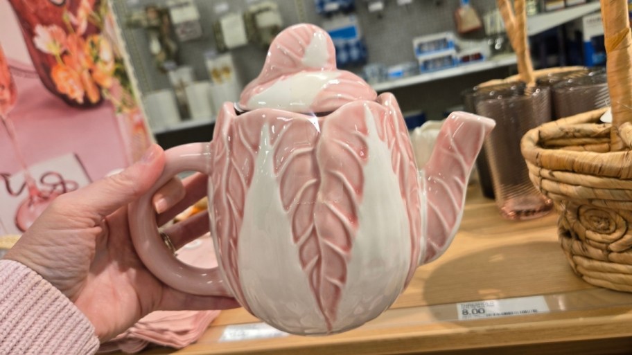 womans hand holding a hand painted radicchio tea pot