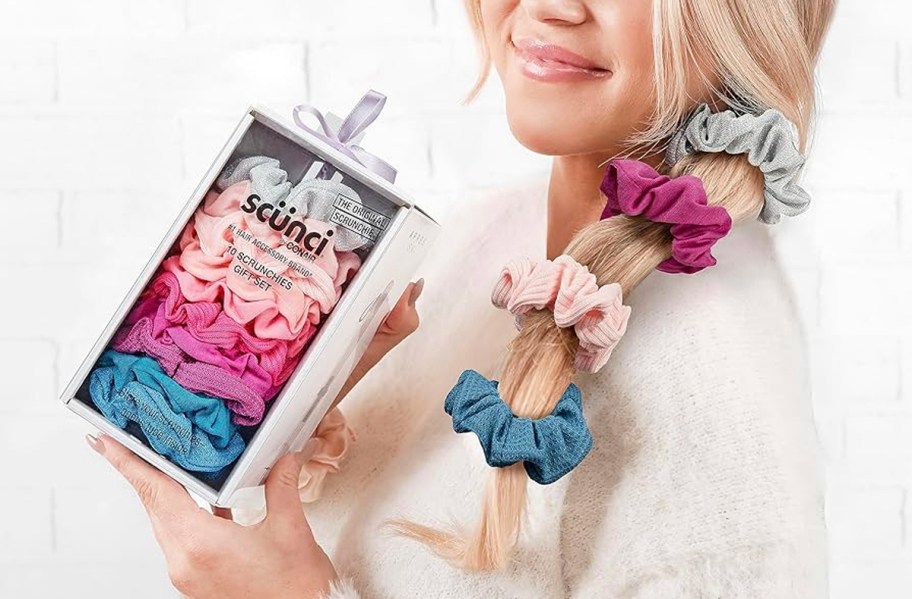 woman holding hair tie giftset box with colorful hairties in hair