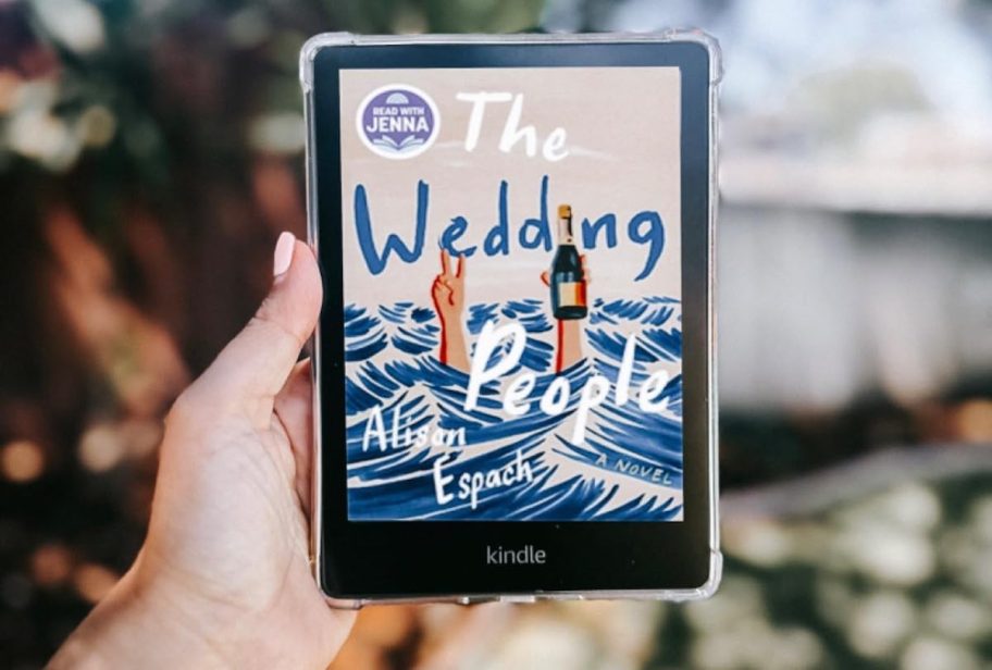 hand holding kindle with the wedding people book on screen